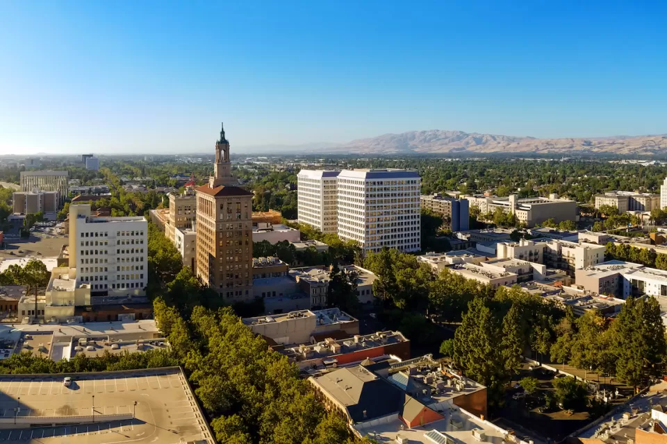 Aerial view of San Jose, California with mountains in background.